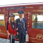 Guest photographed with a train conductor of Fujikyu Railway