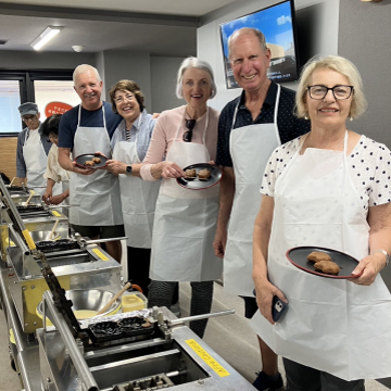 Japan Private Tour guests in a kitchen learning to cook Japanese food